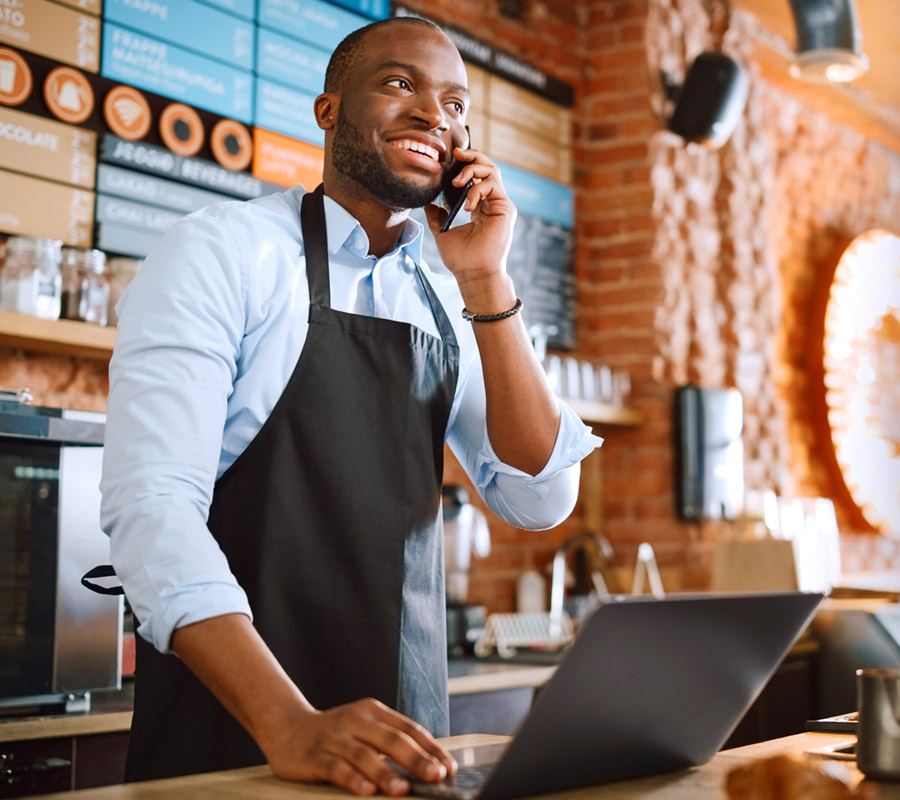 man at counter talking on phone