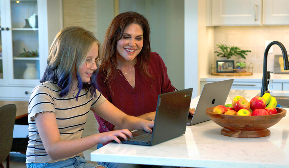 women and girl with laptop computers